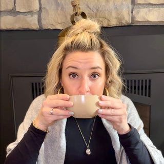 Samantha holding a cup of Peet's coffee at The View Cafe & Gifts